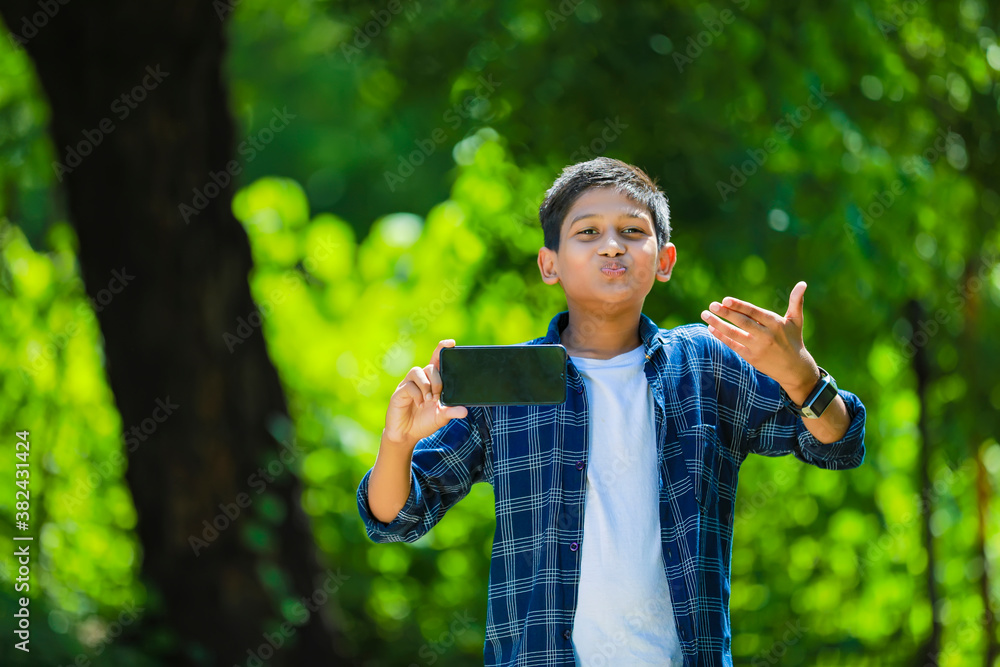indian cute child showing showing smartphone indian cute child showing showing smartphone