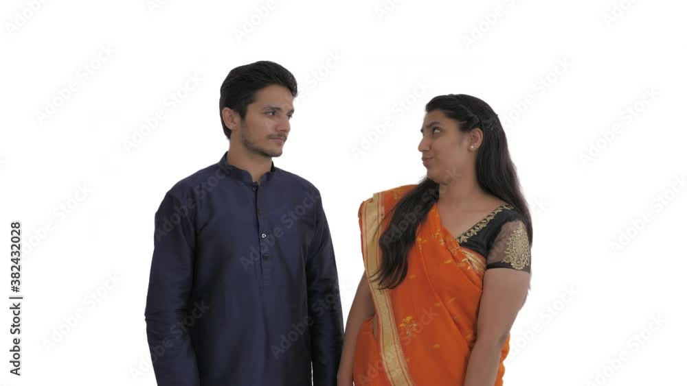 Portrait of young indian couple holding fingers in the shape of guns and simulating shooting in the temple. Expressing dislike of situation. Finger gun gesture. Isolated on white background Portrait of young indian couple holding fingers in the shape of guns and simulating shooting in the temple. Expressing dislike of situation. Finger gun gesture. Isolated on white background