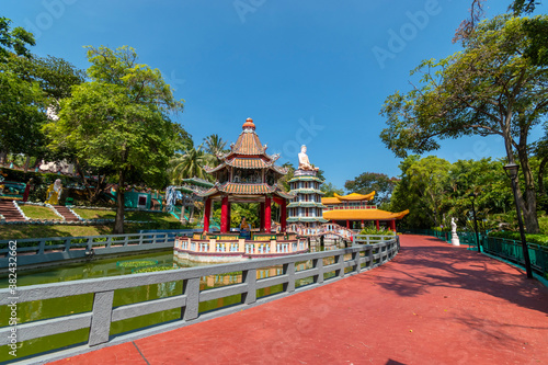 Chinese Pagoda and Pavilion by the Lake at Haw Par Villa Theme Park. This park has statues and dioramas scenes from Chinese mythology, folklore, legends, and history.