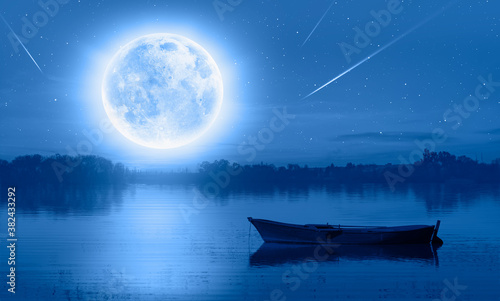 Calm water of blue lake with full moon and boat, falling stars in the background"Elements of this image furnished by NASA"