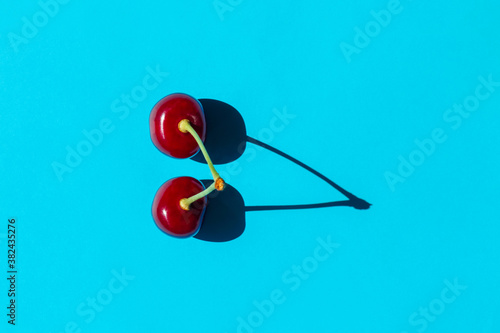 cherry berry with a hard shadow on a plain background. the view from the top. blank for the pattern