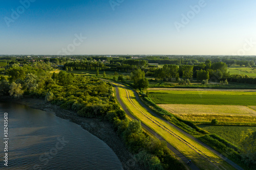 Aerial view of a bike path along the Scheldt river, in Vlassenbroek, Dendermonde, Belgium