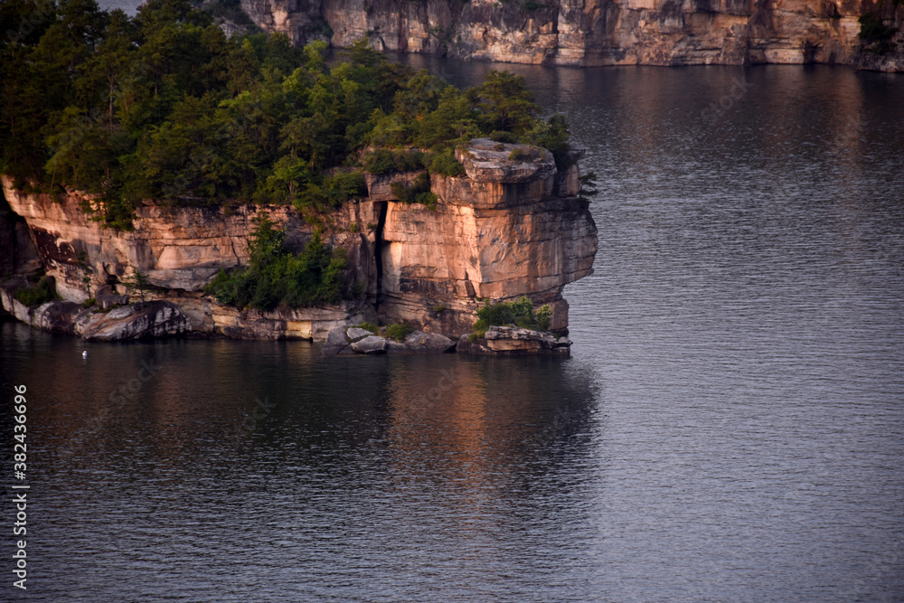 Rocky Cliff reflecting off of lake.