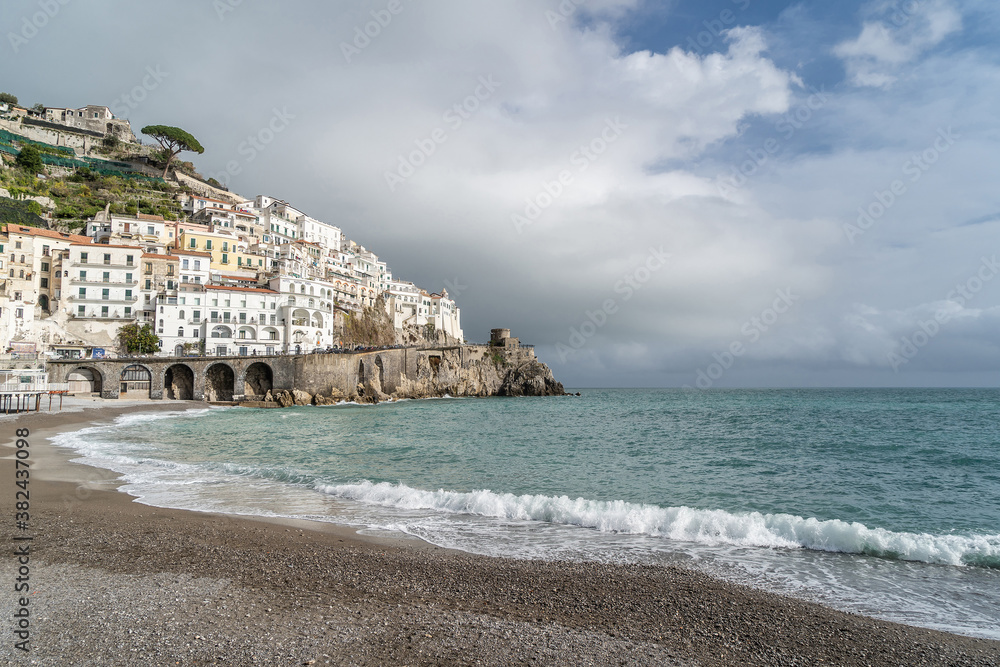 View of Beautiful Amalfi with its beach. Dark sky with incoming thunderstorm. Amalfi Coast, Campania, Italy