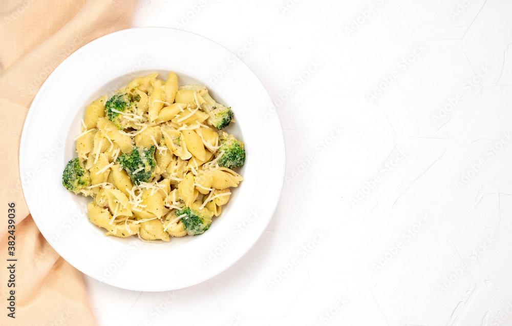 pasta with broccoli in creamy sauce in white plate pasta with broccoli in creamy sauce in white plate