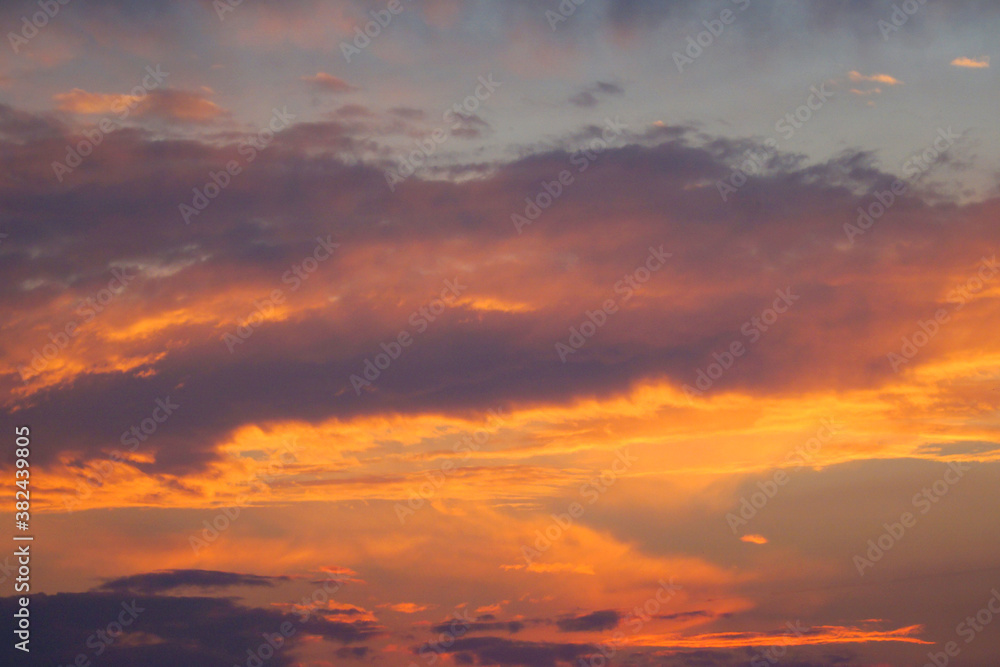  Background of the picturesque evening sky and clouds illuminated by the setting sun.