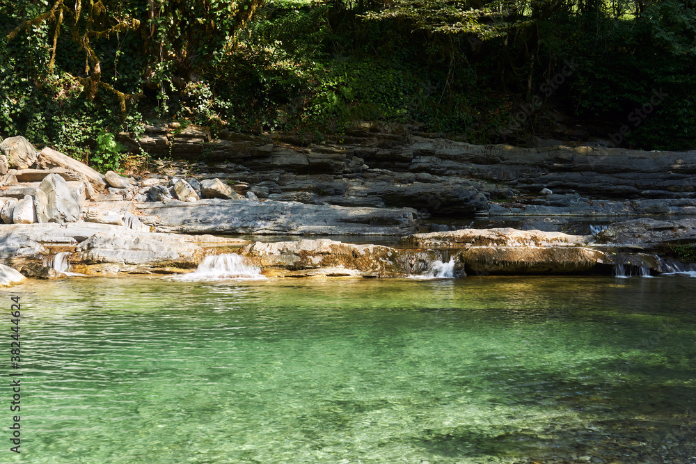 lake on a mountain river with rocky overgrown banks lake on a mountain river with rocky overgrown banks