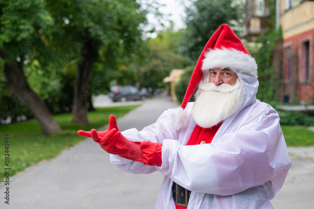 Santa claus in a protective costume puts on gloves.