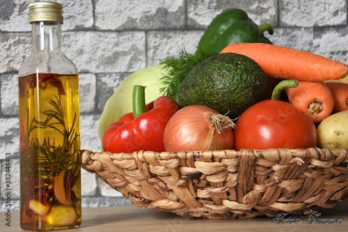 Fototapeta Naklejka Na Ścianę i Meble -  fresh vegetables, olive oil with garlic and rosemary in a bottle