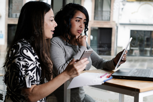 business women working with their laptops in an office © ImagineStock