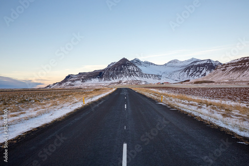 Empty road and mountains in winter, Iceland 