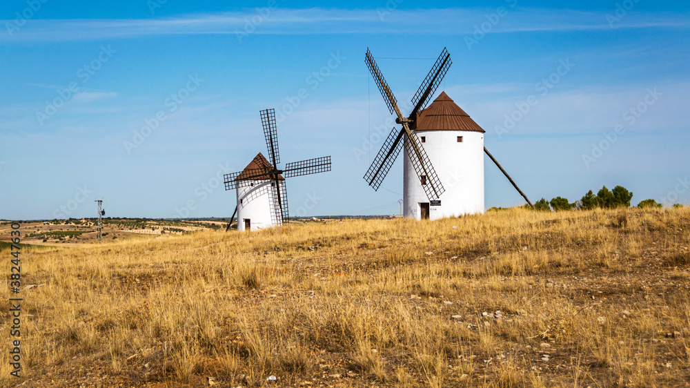Old whitewashed windmills in a field near Mota del Cuervo in Castilla la Mancha, Spain.