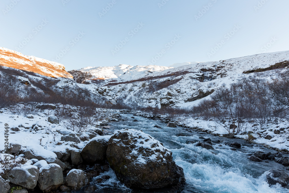 River streaming from the Glymur waterfall in winter, Iceland River streaming from the Glymur waterfall in winter, Iceland
