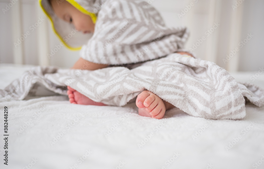 baby's feet close up on a white bed baby's feet close up on a white bed