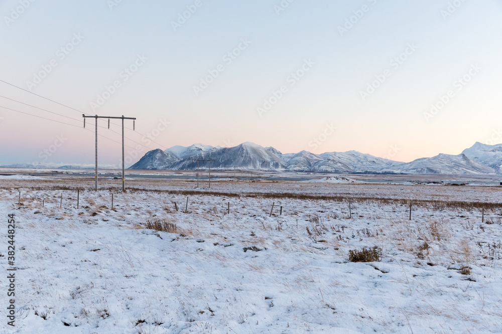 Winter sunrise with electricity pylons in Iceland Winter sunrise with electricity pylons in Iceland