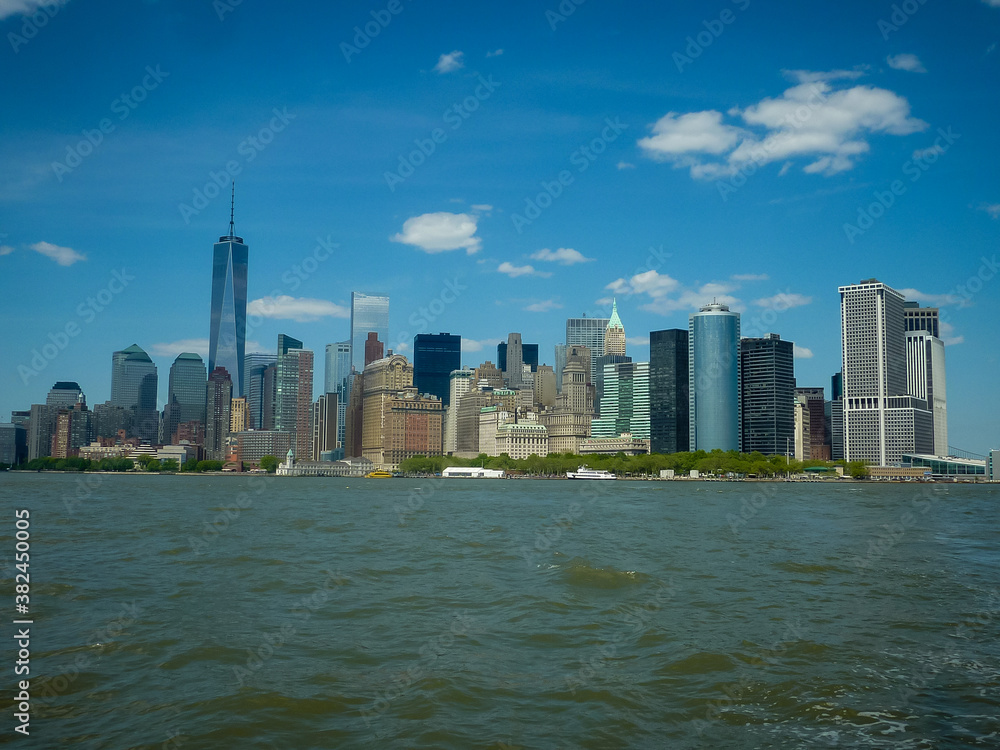 Naklejka premium Lower Manhattan of NYC New York City taken from liberty island. This also known as Downtown Manhattan the largest business district in state of New York and USA.