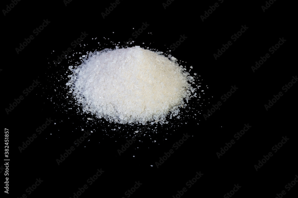 Heap of sea salt grains on a black background
