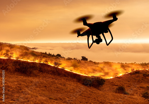Drone flying over wildfire or forest fire on California coast