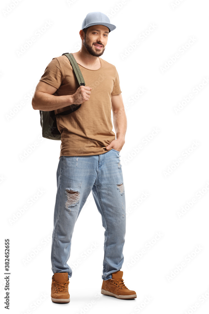 Full length portrait of a guy with a cap carrying a backpack Full length portrait of a guy with a cap carrying a backpack