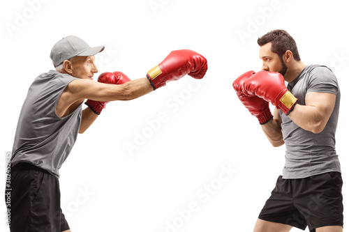 Elderly man and a young man boxing
