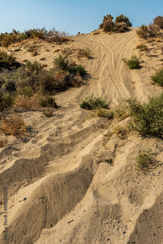 off road ATV vehicle tire tracks up sand dune hill off road ATV vehicle tire tracks up sand dune hill