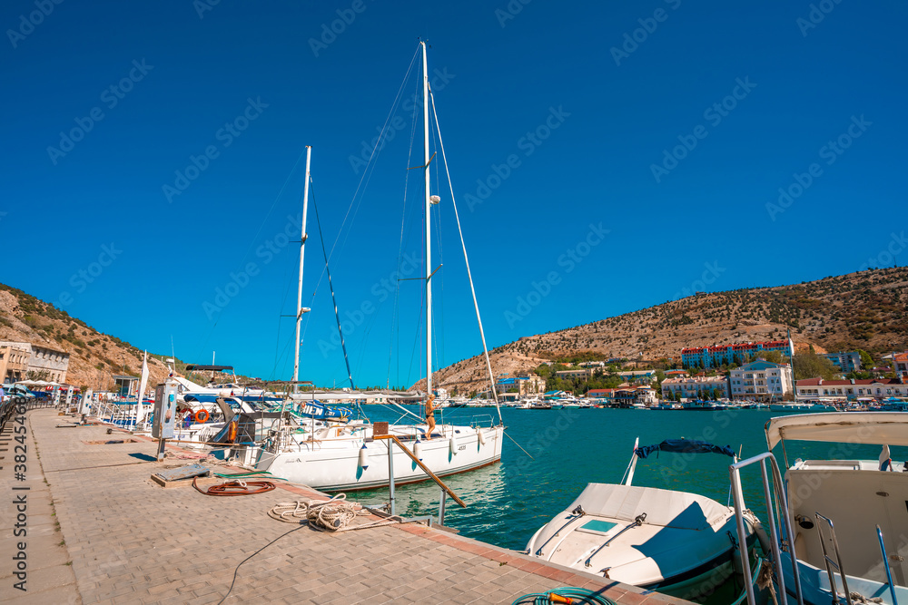 Balaklava / Crimea - 20 Sep 2020: The yachts are located in a Bay with a view of the city and the azure water