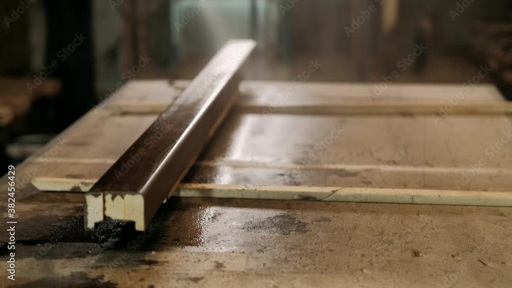 Carpenter applies the varnish to a wood with the help of a air gun. Work in a carpentry workshop. Carpentry, craftsmanship, handwork concept. Carpenter applies the varnish to a wood with the help of a air gun. Work in a carpentry workshop. Carpentry, craftsmanship, handwork concept.