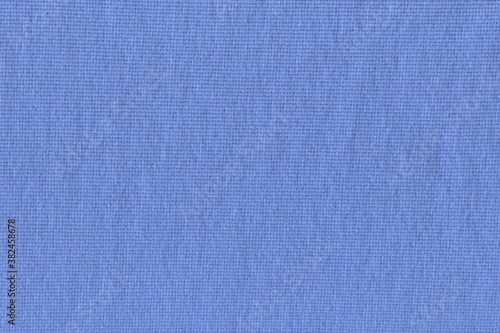 The texture of the blue ribbed knit fabric. Soft natural cotton knit fabric for everyday wear. The background is blue.