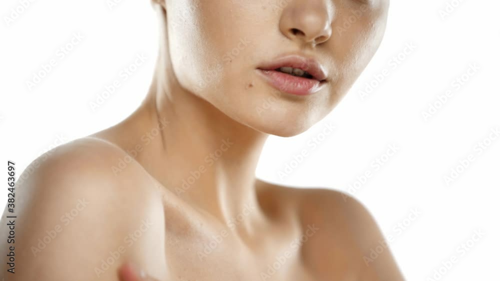 Cropped view of young woman applying lotion on shoulder isolated on white Cropped view of young woman applying lotion on shoulder isolated on white