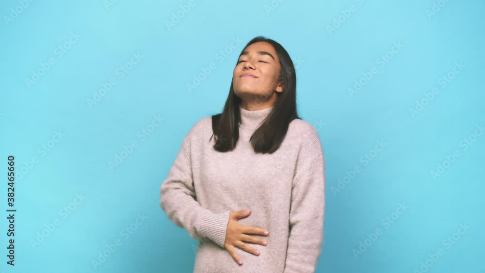 Young mixed race indian woman touches tummy, smiles gently, eating and satisfaction concept Young mixed race indian woman touches tummy, smiles gently, eating and satisfaction concept