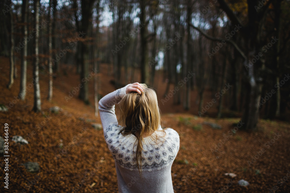 Blond woman standing in the woods Blond woman standing in the woods