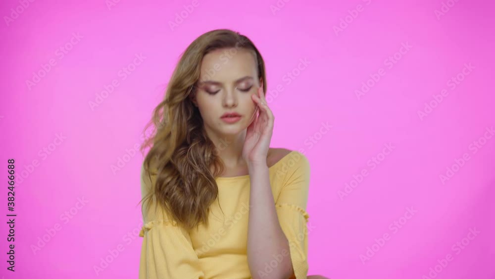 Young woman posing, touching face and hair isolated on pink Young woman posing, touching face and hair isolated on pink