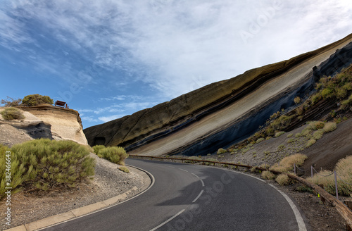 A curve on the road to the caldera. At the Tarta del Teide viewpoint  there is an open cliff with layers of lava ash in fascinating colors. It is a sunny September day.