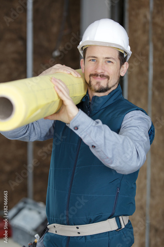 professional construction engineer holding paper roll