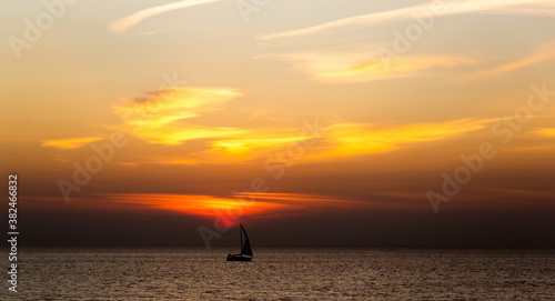 Boat sailing along against a vivid colorful sunset..Gulf of Finland.