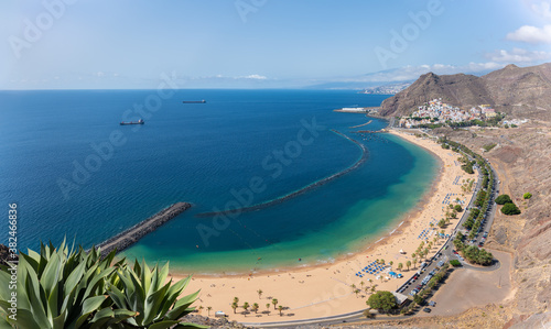 A white dream beach in the east of Tenerife near the village of San Andres. View from a lookout point over the coastline. Parts of the island's capital can be seen in the background.