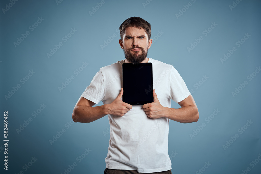man with tablet near face on blue background cropped view touch monitor new technologies Copy Space man with tablet near face on blue background cropped view touch monitor new technologies Copy Space