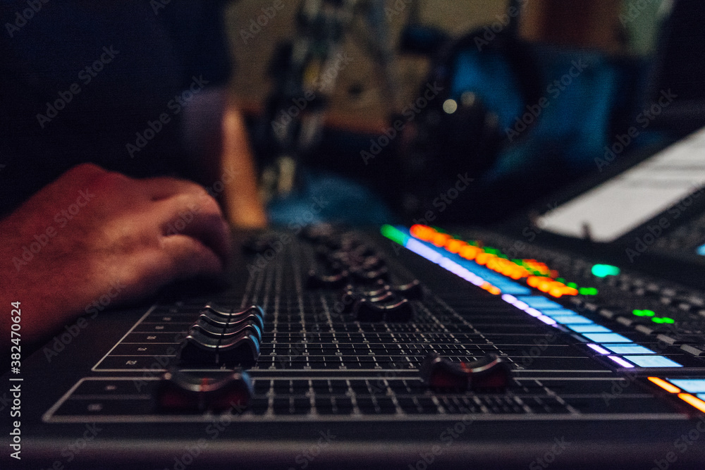 Hands of a sound engineer on a mixing board Hands of a sound engineer on a mixing board