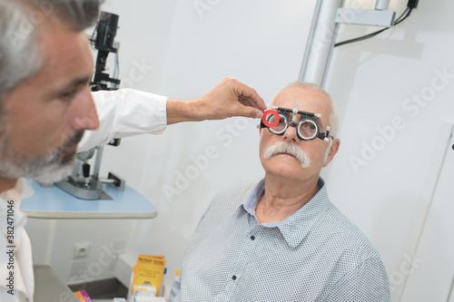 older man having an eye test examination at clinic