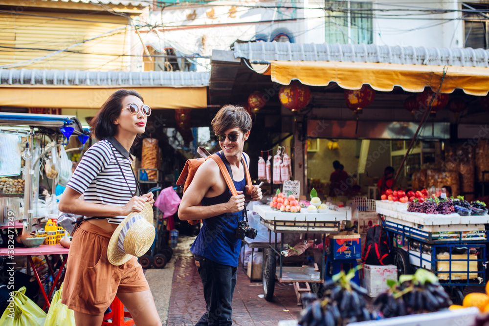 Couple Walking at the Marketplace Couple Walking at the Marketplace