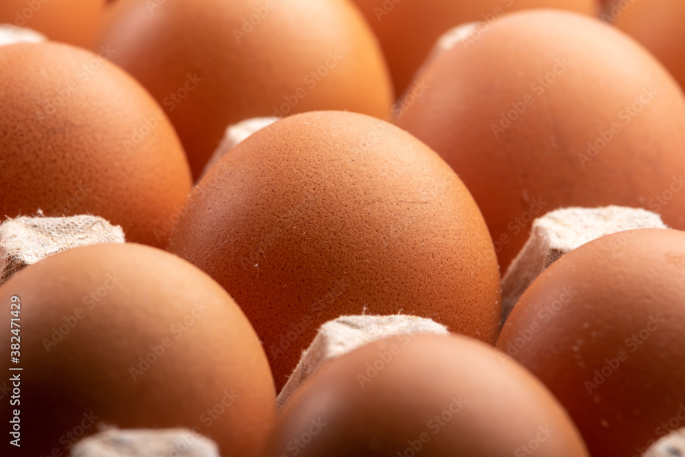 closeup of brown chicken eggs in a carton closeup of brown chicken eggs in a carton