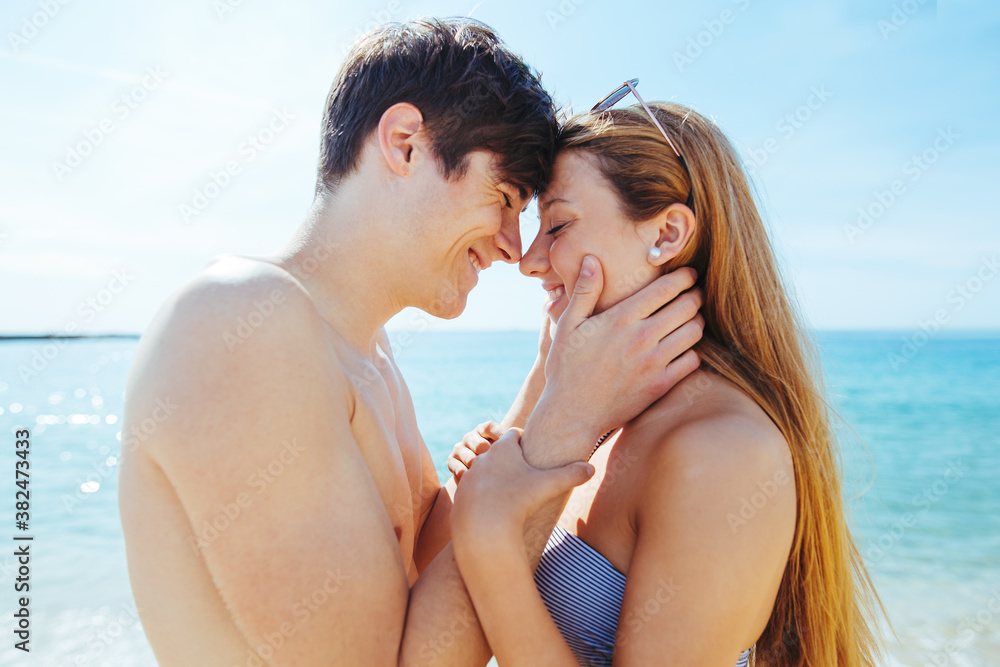 Portrait of a teenage couple in love on the beach in summer. Portrait of a teenage couple in love on the beach in summer.