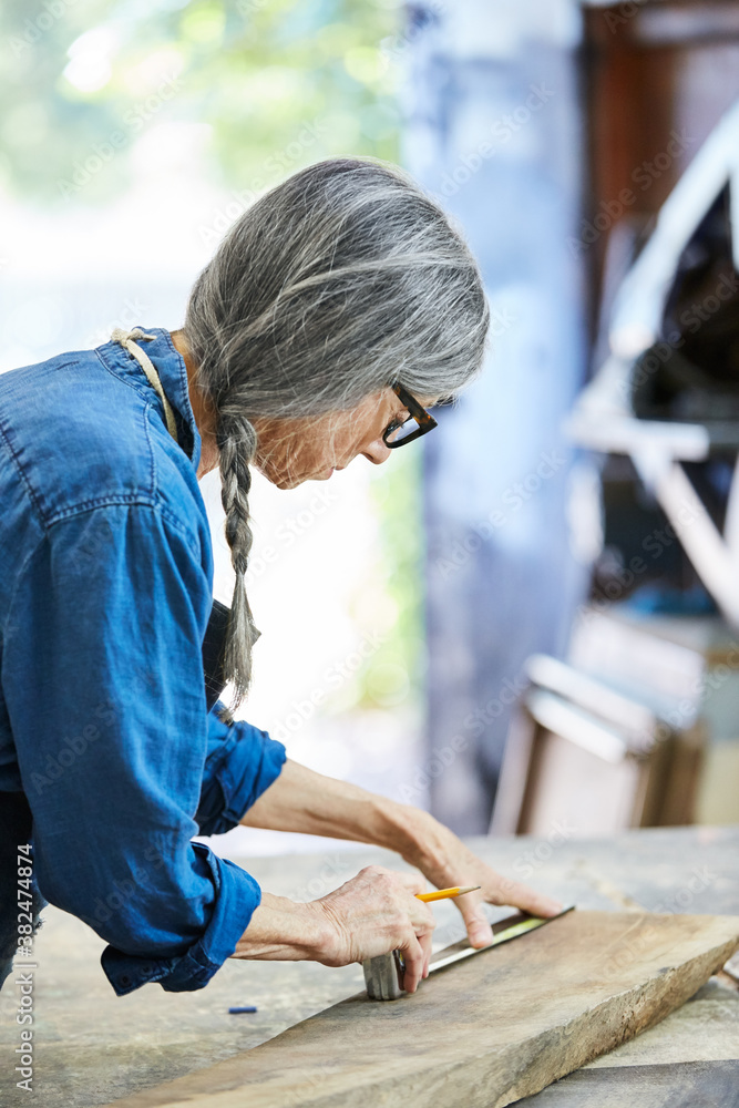 Portrait of senior woman inside her wood shop Portrait of senior woman inside her wood shop