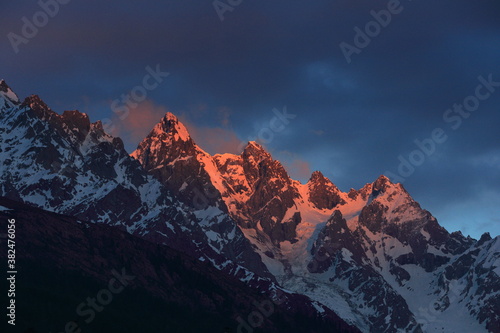 Sunset at snow covered mountains photo