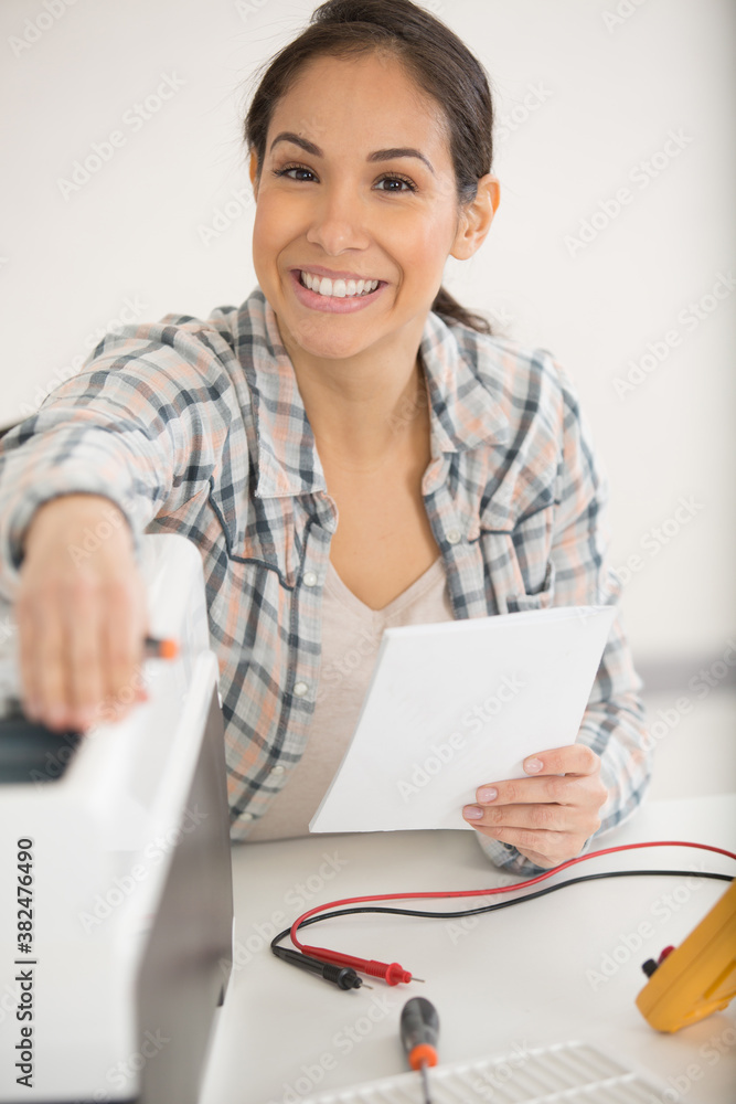 female technician working on an electrical appliance female technician working on an electrical appliance