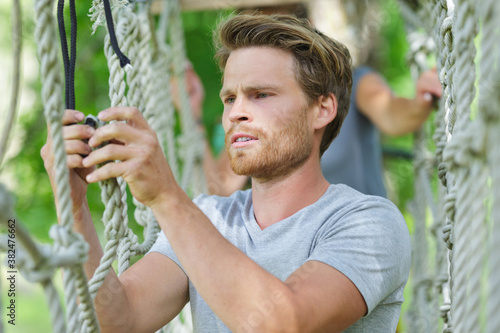 man spend their leisure time in a ropes course