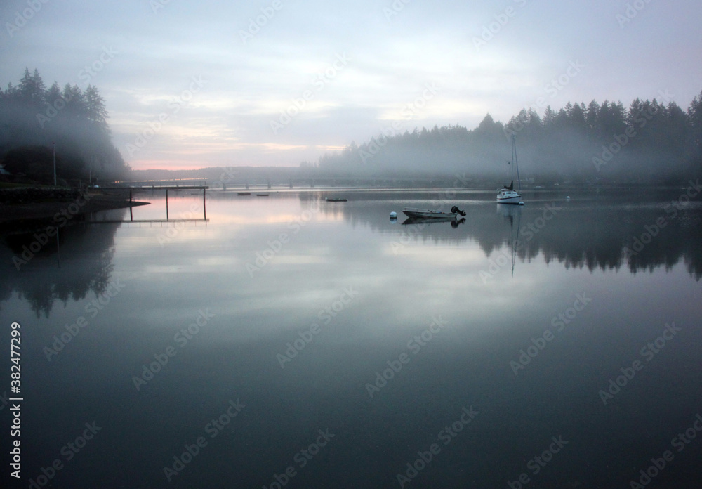 Fototapeta premium Peaceful seascapes with rippled water, buoys, boats, and dynamic skies and reflections