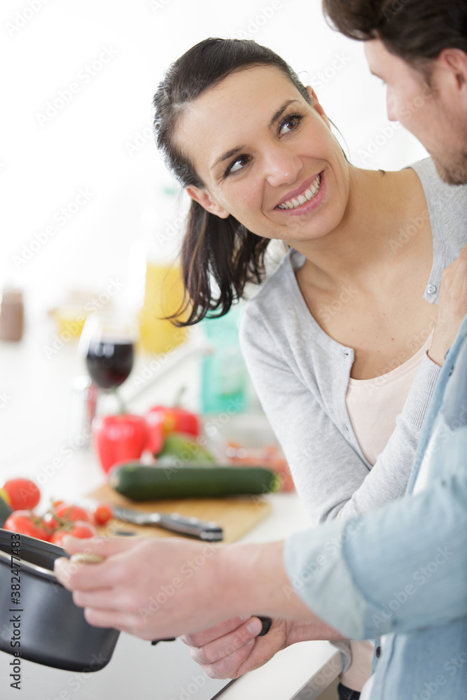 young people having fun cooking together in home kitchen young people having fun cooking together in home kitchen
