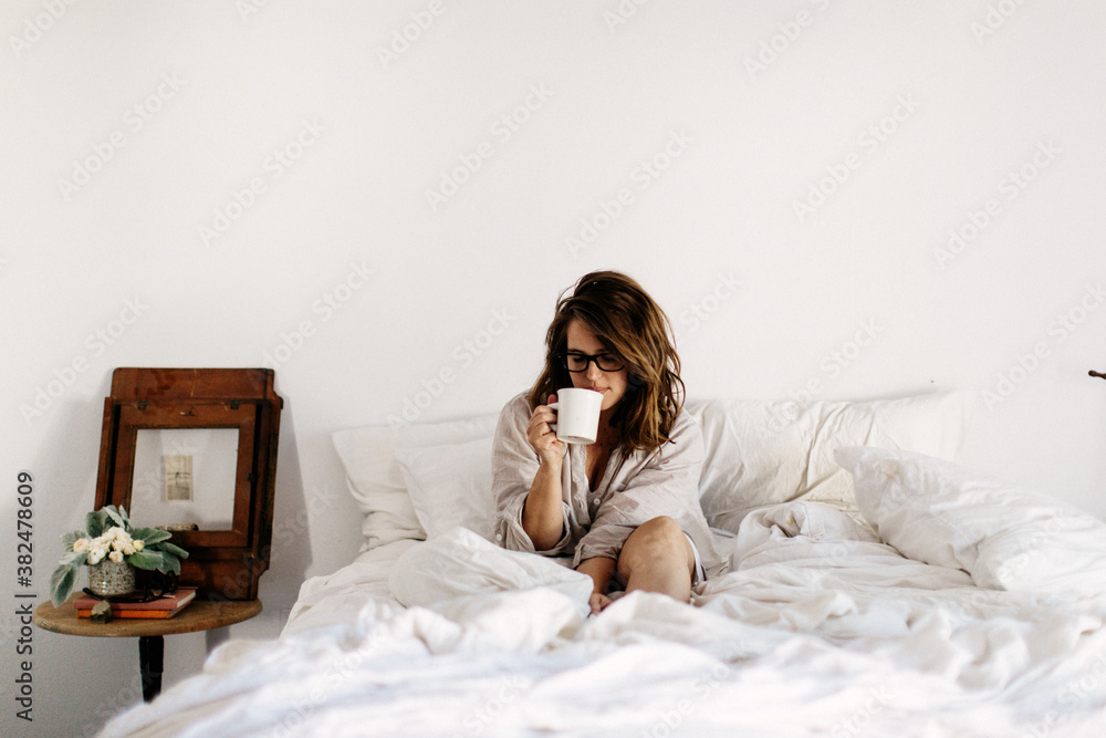Woman sitting on bed Woman sitting on bed