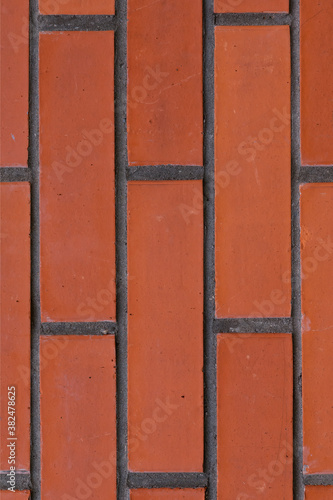 dark red brick wall with cement lines vertical pattern background solid